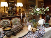 Tablescape with African Tribal Art, an Ikat textile, Danish bronze bowl, 1920s Murano glass
